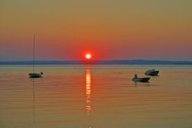 boats at sunset greeting card